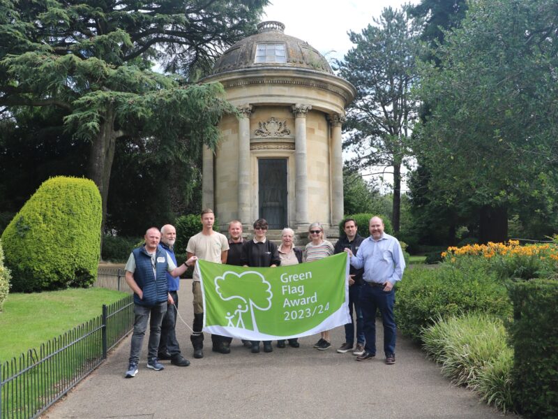 green flag award flag being held by park staff