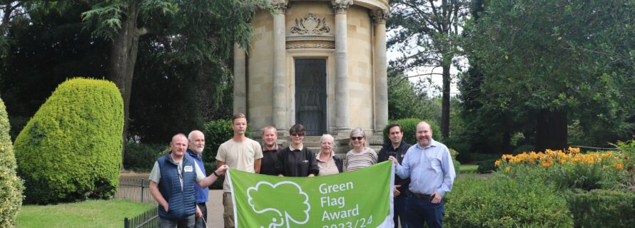 green flag award flag being held by park staff