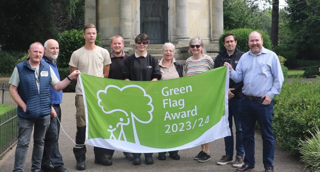green flag award flag being held by park staff