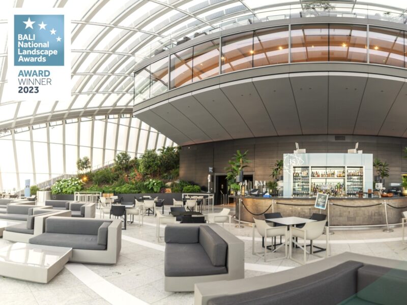 wide angle shot of sky garden chairs, bar, and garden