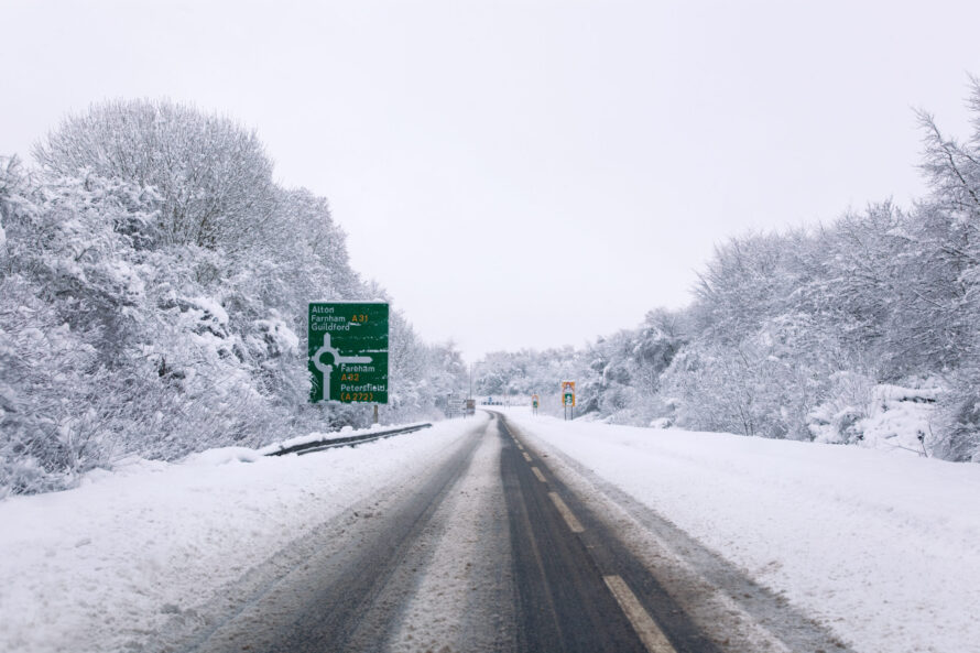 The A31 road at the junction with the A32 roundabout during snow