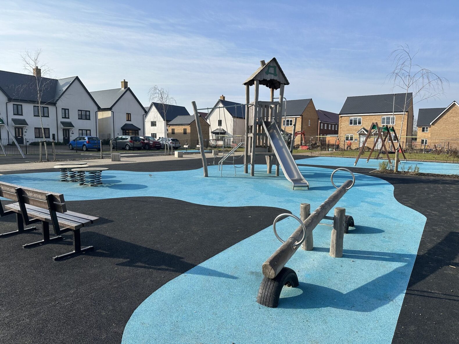 Play area for Vistry Homes, Sawtry, featuring wetpour, manufactured from sourced material from the UK and Western Europe only, comprising of layers made from end-of-life truck tires. Sensory movement values such as swinging, bouncing, sliding and rocking are incorporated into the design.