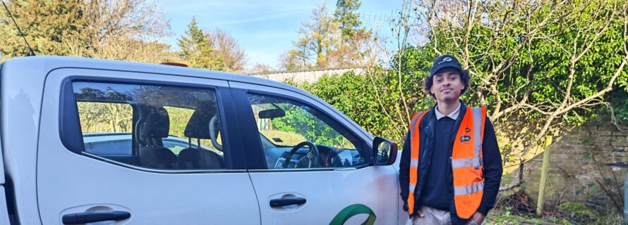 person standing next to white idverde van